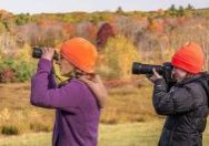 photo by Bill Byrne of birders wearing orange